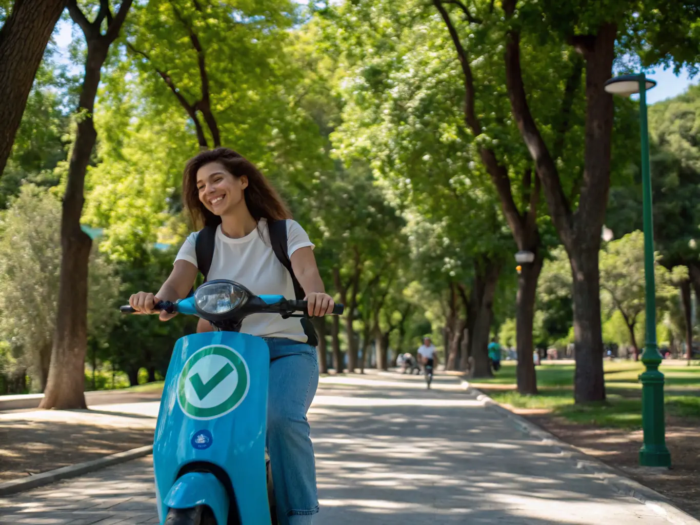 A cyclist smiling while riding an electric bike through a park, showcasing the joy and ease of use.